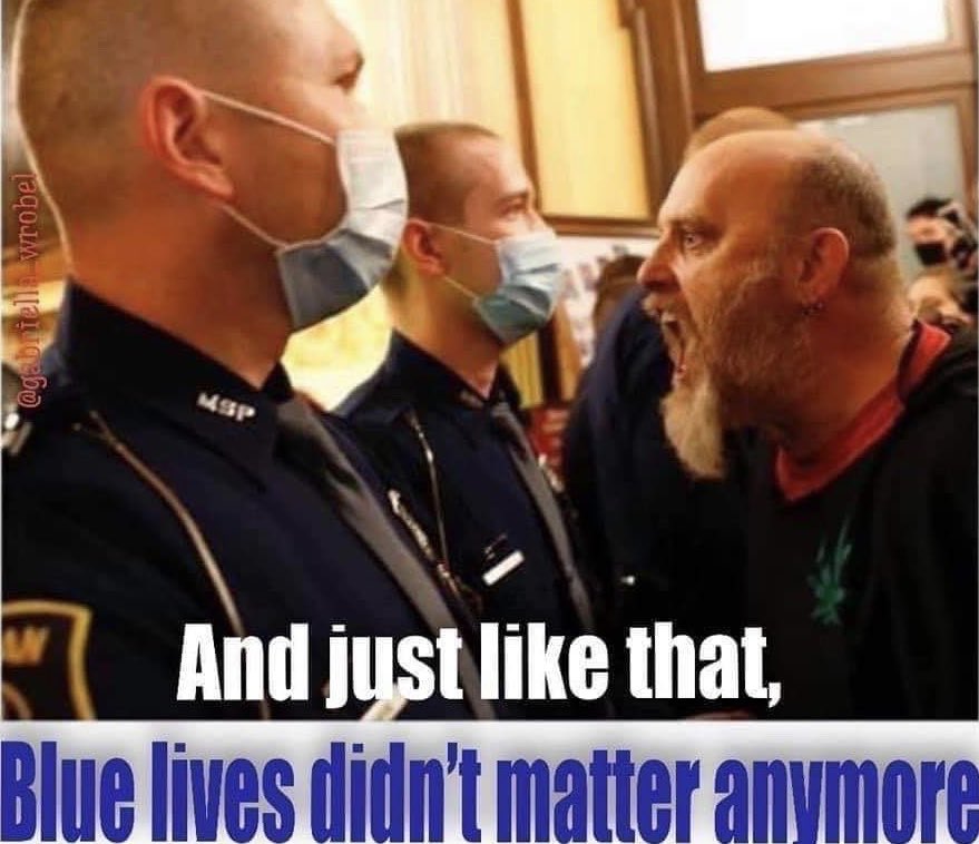 An angry white male unmasked protester yells in the face of masked police above the caption "and just like that, blue lives didn't matter anymore."