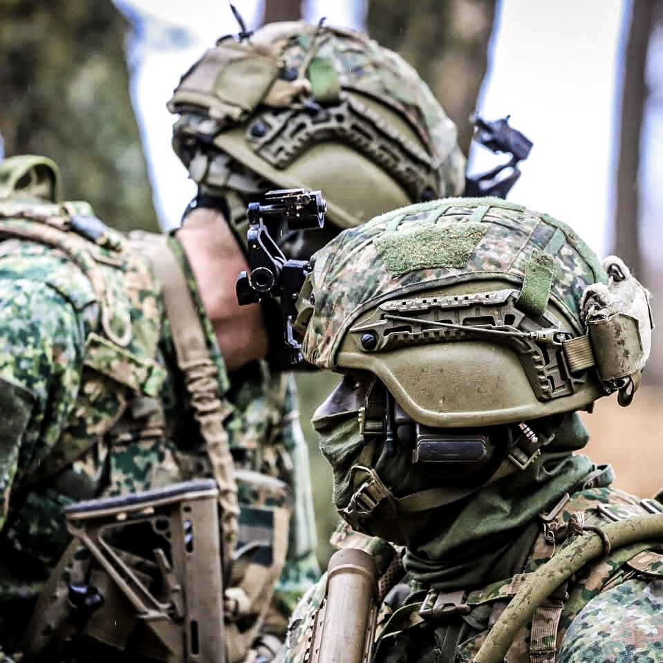 Two soldiers in gear keeping watch.
