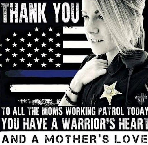 Female police officer in front of blue lives matter flag with the words "Thank you to all the moms working patrol today. You have a warriors heart and a mother's love."