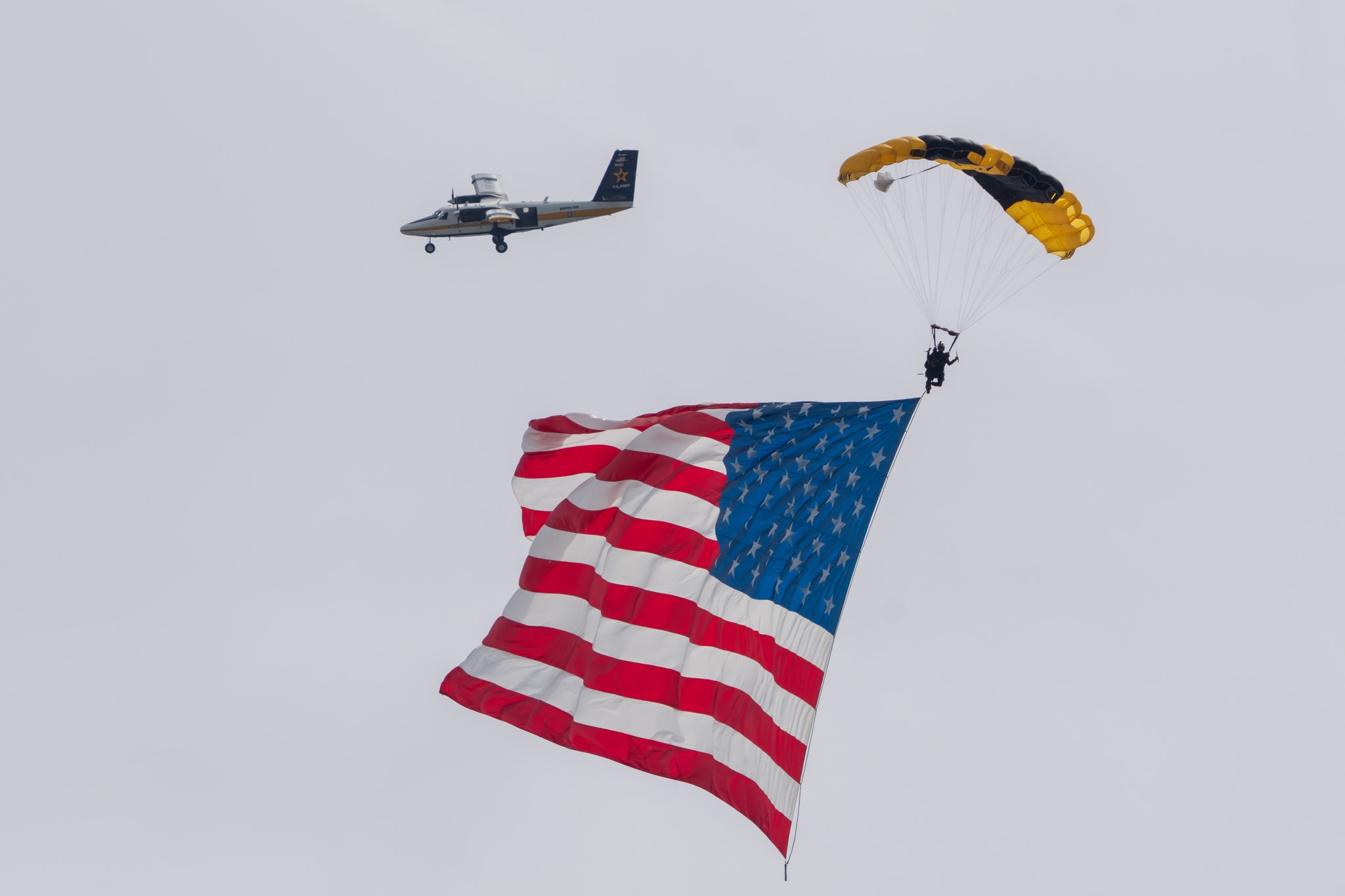 Skydiver with American flag and the plane.