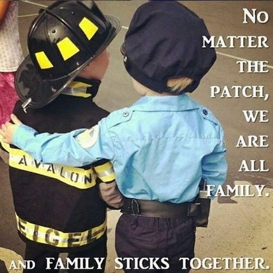 A young boy dressed as a police officer puts his arm around a young boy dressed as a fireman beneath the words "No matter the patch, we are all family, and family sticks together."